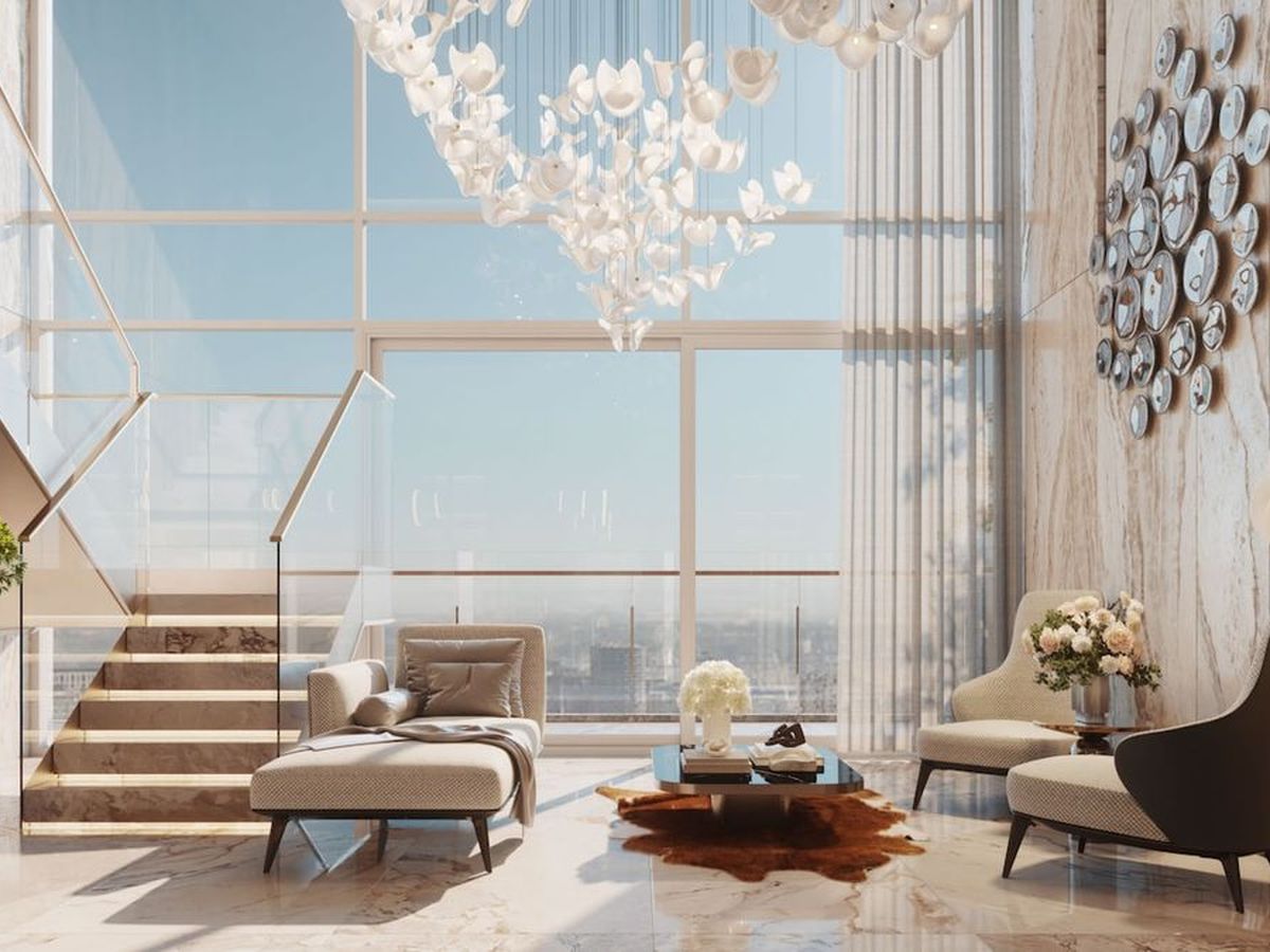 Sunlit luxury living room with floor-to-ceiling windows and a chandelier